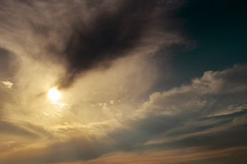 Rays of light shining through dark clouds for background