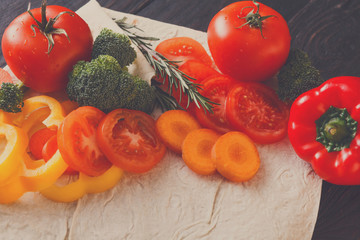 Fresh vegetables on pita bread background.