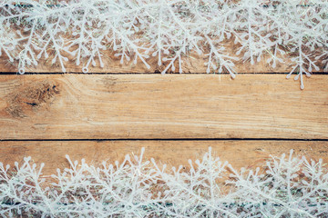 Wooden brown christmas background and snowflakes with space.