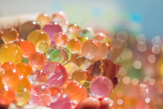 Colored balls of water beads, hydrogel in in hands. Sensory experiences
