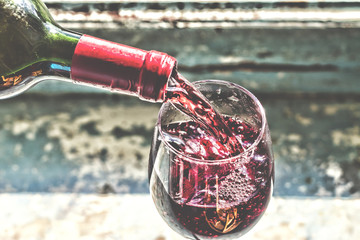 Pouring wine, pouring red wine. Wine in a glass, selective focus, motion blur, Red wine in a glass.