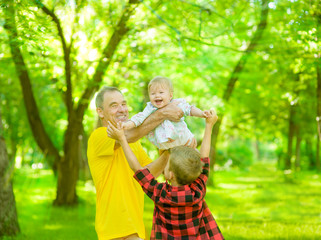 Fototapeta premium Grandfather having fun with his grandchildren in the park