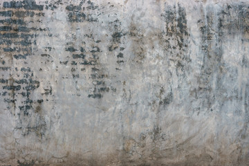Old dirty cracked gray concrete wall background.