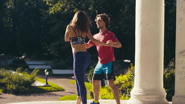 Young couple dancing on the square