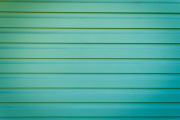 Fototapeta premium The green metal wall is goffered