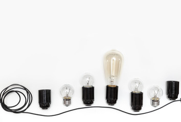 Retro light bulb, cartridges and wires for retro garlands on a white background isolated. View from above