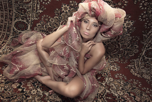 Portrait of a girl model on the background of carpets. Asian culture, east, style, fashion, beauty.