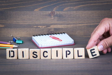 Disciple from wooden letters on dark texture background