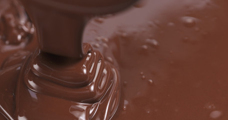 pouring melted premium dark chocolate