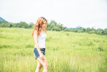 Asian women travel relax in the holiday. on a green pasture.