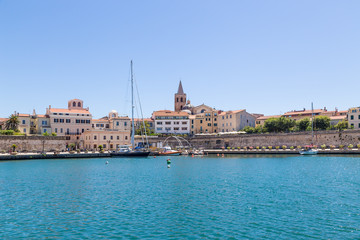 Fototapeta premium Alghero, Sardinia, Italy. Boats and yachts in the port against the walls of the fortress