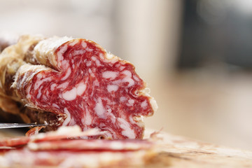 part of dried italian salami on table