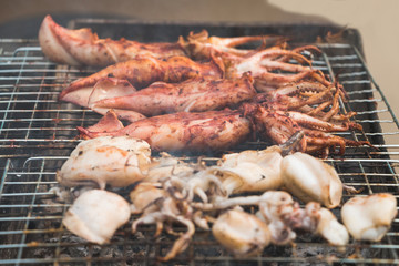 Squid grilled with smoke on selective focus
