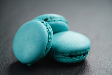 bright azure macarons on slate background