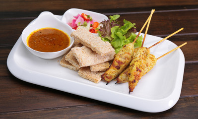 Satay Chicken , Sate Ayam with Peanut Sauce and bread , Asian skewers famous food