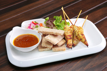 Satay Chicken , Sate Ayam with Peanut Sauce and bread , Asian skewers famous food