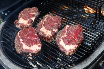 Closeup of a beef steak on the grill. Shallow depth of field