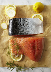 Prepared raw salmon fillets on parchment paper