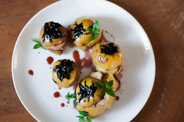 Baked apples with cottage cheese, chocolate, nuts, mint. Apples on a white plate