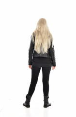 full length portrait of blonde girl wearing black leather outfit, standing pose on white background.