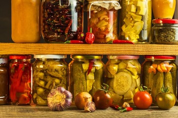 Jars with variety of pickled vegetables. Carrots, field garlic, parsley in glas. Preserved food....