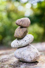 Smooth stones balancing on one another in a garden setting