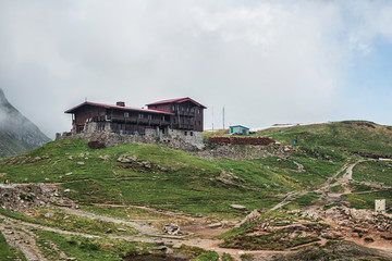 Mountain landscape, house on the hill in Carpathians, Romania