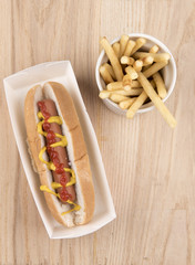 Hot dog with ketchup, mustard and fries