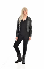Fototapeta premium full length portrait of blonde girl wearing black leather outfit, standing pose on white background.
