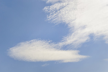 Blue sky with white spindrift clouds. Day, background.