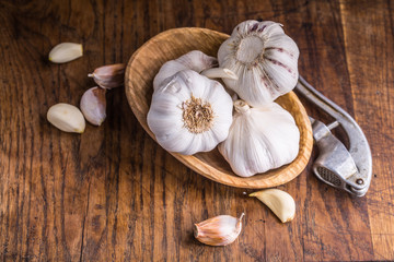Garlic. Garlic Cloves and Garlic Bulb in vintage wooden bowl