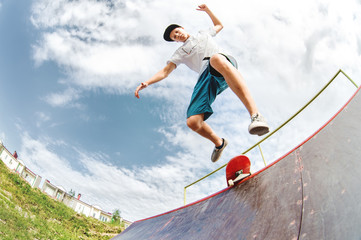 Young skater jumps from ramp down