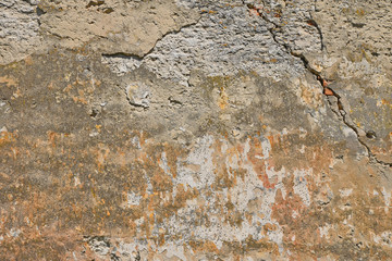 Dirty wall with peeling plater and rusty stains