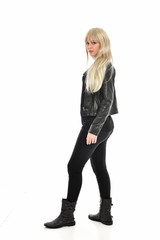 Fototapeta premium full length portrait of blonde girl wearing black leather outfit, standing pose on white background.