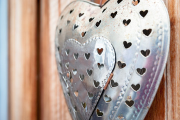 Decorative metal heart on wooden wall