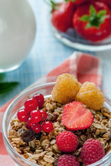 Healthy Breakfast cereals muesli with fruits and berries strawberries, raspberries and red currants with dairy products. Selective focus.