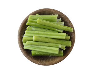Fresh celery in wooden bowl isolated on white background. Top view. Celery with copy space for text.