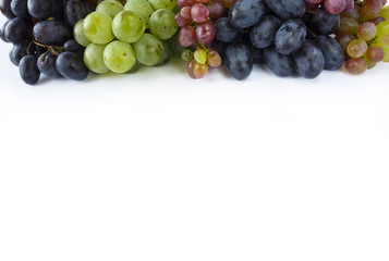Grapes on white background. Grapes at border of image with copy space for text. Top view.