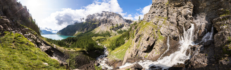 Panorama of torrent stream, lake, green valley in Alps mountains © NicoElNino