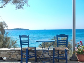 Fototapeta premium Image showing table and chairs of a traditional tavern at a Greek island.