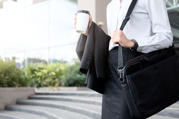 Business woman walking drinking coffee.