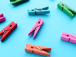 many colored clothespins on a blue background, as a substrate, pin; clothes peg