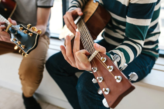 Learning to play the guitar. Music education.
