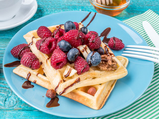 Homemade waffles with raspberries and blueberry