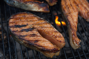 Grilled salmon red fish steaks on the flame