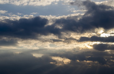 Cumulus clouds with sun rays, dramatic sky