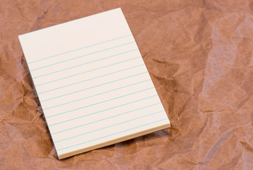 Lined Blank Scratch Pad on Textured Background