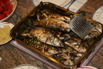 Fish grill / There are fish on the grill and grilled. An raw freshwater fish on the grill. Cooked in traditional style. Cooking of salted fish on a grill stove.