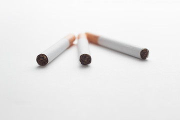 Close-up of a group of cigarettes on a white background
