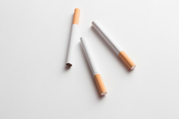 Close-up of a group of cigarettes on a white background